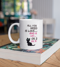 Load image into Gallery viewer, Cat Coffee Mug -Funny Cat Lovers Gift For Women Or Men - &quot;All You Need Is Love And A Cat Or 2 Or 3&quot;
